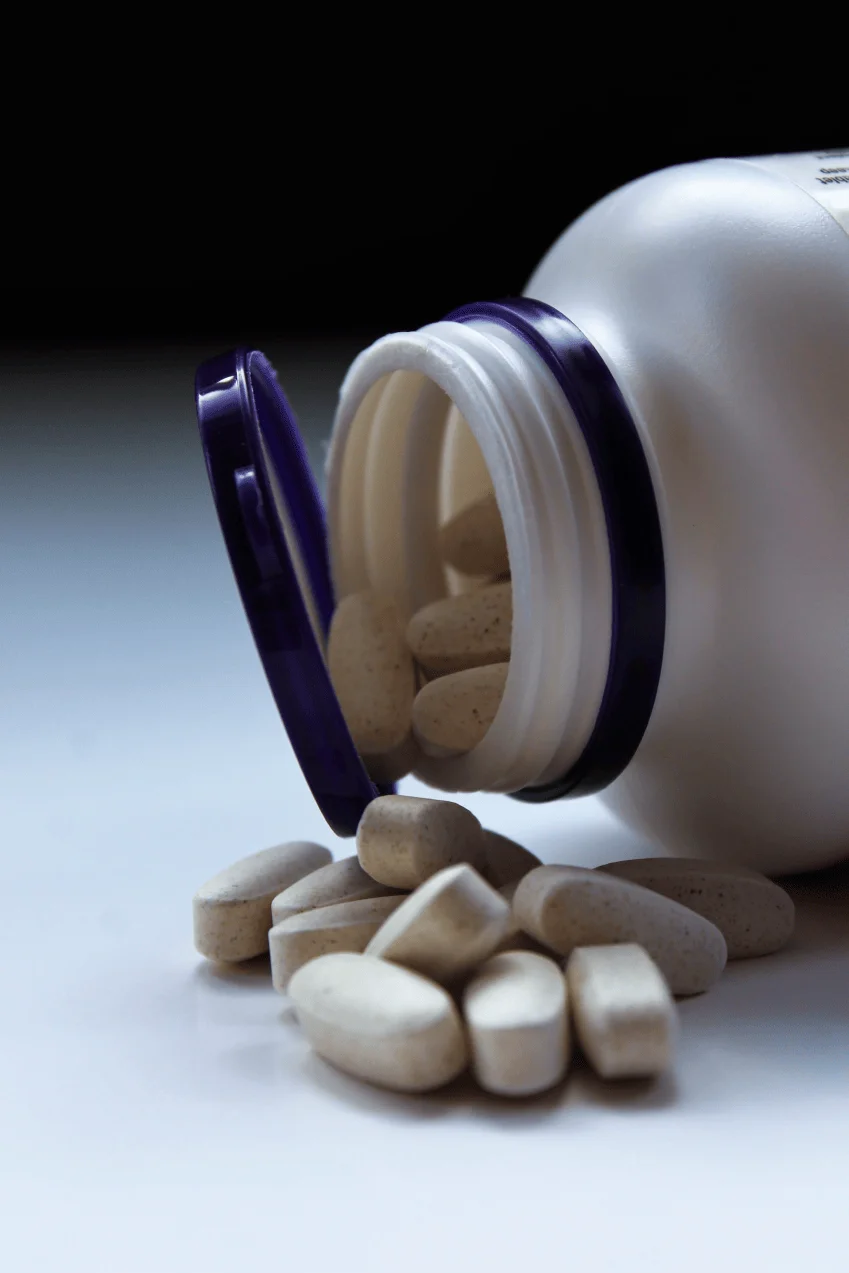 a photo image of pills beside a medicine bottle iro of Protea Pharmacy dispensary